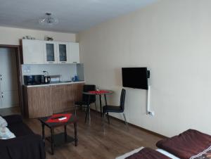 a living room with a couch and a kitchen at Studio Zora in Burgas