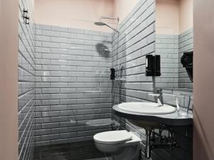 a bathroom with a toilet and a sink at HOLA GDYNIA in Gdynia
