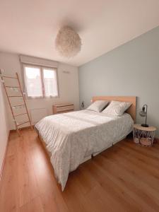 Un dormitorio con una cama grande y una escalera en Cocon Urbain - avec parking privé gratuit, en Toulouse