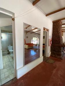 a living room with a large mirror in a room at CaminAndes Hostal in San Pedro de Atacama +141 photos