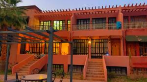 a building with stairs and a table in front of it at Villa Marrakech in Marrakesh