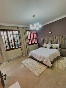 a bedroom with a large bed in a room with windows at Villa Marrakech in Marrakesh +96 photos