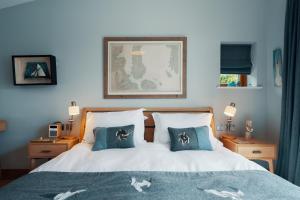 a bedroom with a bed with two pillows on it at Air an Oir - Skye Self Catering in Portree