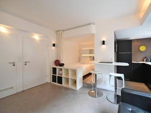 a small apartment with a bed and two stools at Limpersberg - Amazing and cozy flat in Luxembourg
