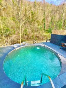 a swimming pool with two chairs and a bench at ozlifesapanca dome in Sapanca