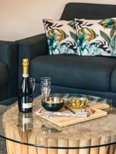 a bottle of wine sitting on a table with a wine glass at Appartement climatisé avec garage au cœur du centre ancien in Sainte-Maxime