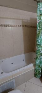 a white bath tub sitting in a bathroom at Apartment Amdar Village עם ממ"ד in Eilat