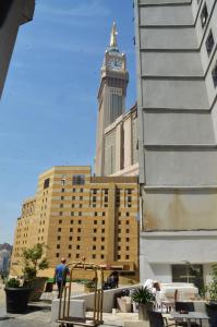 a building with a clock tower on top of it at Hamad Saif Batal Hotel in Mecca