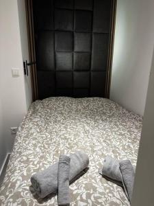 a bed with two pairs of socks on it at Amazing cosy flat Lux Gare in Luxembourg