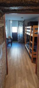 a room with two bunk beds and a table at Casa do Carregal in Braga