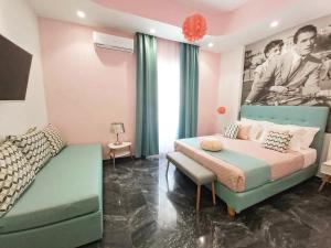 a bedroom with a bed and a couch at Nostalgia Retro Suites in Naxos Chora