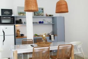 a kitchen with a table and chairs and a refrigerator at Loft de playa in Mar del Plata