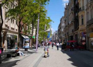 a person riding a stroller down a city street at Amazing Hyper Central Flat- Esch in Esch-sur-Alzette +1 photo