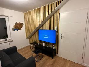 a living room with a couch and a television at Amazing Hyper Central Flat- Esch in Esch-sur-Alzette