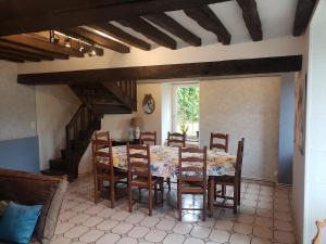 a dining room with a table and chairs at Le Val Nicol in Domfront