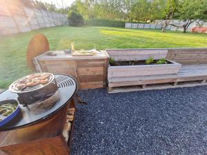 a grill with a pot of food on a table at Rock and chill house with jacuzzi Namur Ardennes in Namur