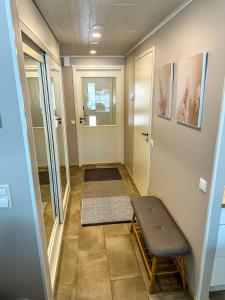 a hallway with a door and a bench in a room at Vuokatin kultaranta in Sotkamo