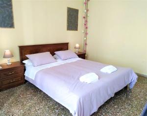 a bedroom with a large white bed with two pillows at Amelie in Loutraki
