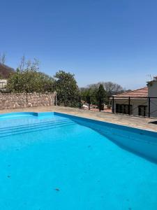 a large blue swimming pool in front of a house at Departamento zona residencial CON PILETA in Salta