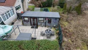 an aerial view of a tiny house with a patio at Bumble’s Barn in Slamannan