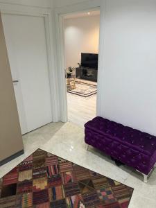 a purple couch in a room with a living room at Parvaneh in Buyukcekmece