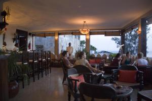 a group of people sitting in a restaurant at Al Johari Hotel & Spa in Zanzibar City
