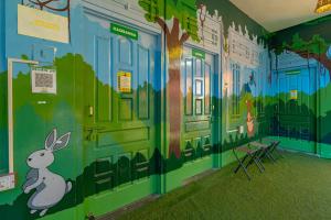 a room with a mural of a rabbit on the wall at Jungle Hostel by Whoopers in Kasol