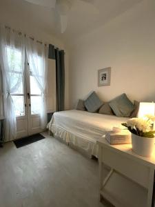 a bedroom with a bed and a table and a window at Home Away From Home Marbella in Marbella