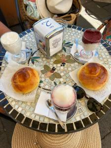 a table with three donuts and two cups of coffee at Casa MiLù in Canneto +37 photos