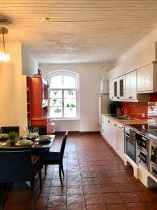 a kitchen with a table and a dining room at Secret Garden Villa in Pörtschach am Wörthersee