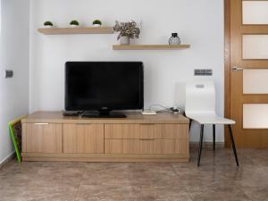 a television sitting on top of a wooden entertainment center at Villa Victor in Riumar