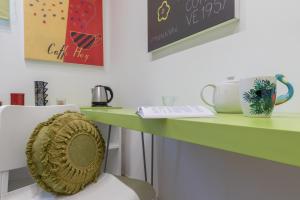 a green desk with a chair in front of it at La casa di Nina - Meda in Meda