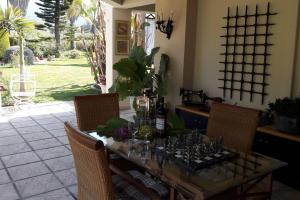 a dining room table with bottles and glasses on it at villa in paradise in Zipárion