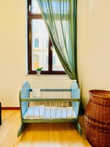 a blue crib sitting in front of a window at (PLANTROOM9)Ganze Wohnung allein in Halle an der Saale