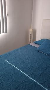 a bedroom with a bed with a blue blanket at Habitación Privada in Ibagué +13 photos