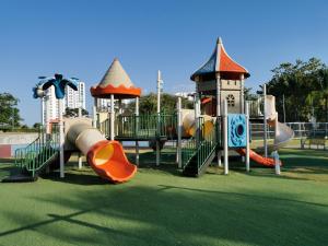 a park with a playground with a slide and a slideintend at Lulu Village - Beach - Pool - Pet Friendly in Coclé