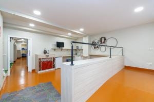 an empty room with a kitchen and a staircase in a house at Turoqua Hostel in Pontevedra