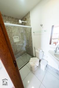a bathroom with a shower and a toilet and a sink at Complexo Papaco's in Anchieta