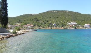 a body of water with a mountain in the background at Apartments Bubica in Luka