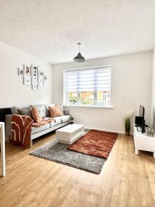 a living room with a couch and a window at Luxury 2 Bed Apartment Stansted Airport Bishops Stortford in Bishops Stortford