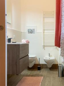 a bathroom with a toilet and a sink at Poggio della Guardia - Montegrosso Rooms in Montegrosso
