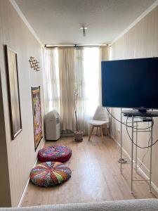 a living room with a flat screen tv on the floor at Esperanza in Los Andes