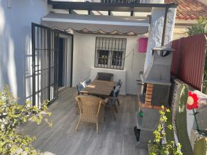 patio con mesa y sillas en el balcón en Casa con Encanto en Roquetas de Mar, en Roquetas de Mar