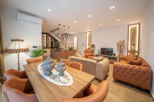 a living room with a table and chairs and a couch at Apartments Nikčević in Kotor
