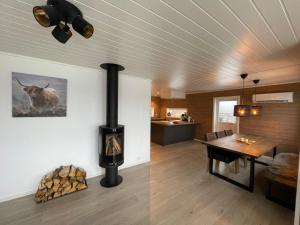 a living room with a wood stove and a kitchen at Lakes and mountain, we got both! in Moi
