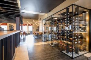 a tasting room with a large glass display case with wine bottles at Hotel Le 830 Namur in Namur +73 photos
