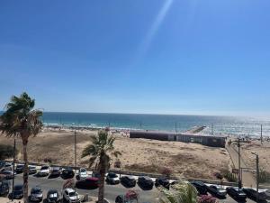 a train in a parking lot next to the beach at The View Costa Caparica in Costa da Caparica