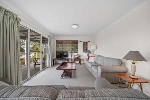 a living room with a couch and a table at Bowen View in Hyams Beach