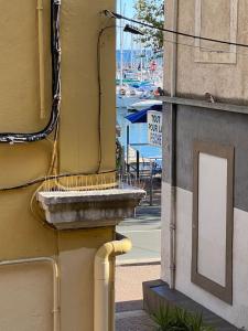 a corner of a building with a sign on the side at Le Coeur du Port de Golfe Juan - Parking - Clim - Wifi in Vallauris