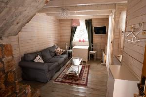 a living room with a couch and a table at ZlatAir Eco Chalet in Nova Varoš